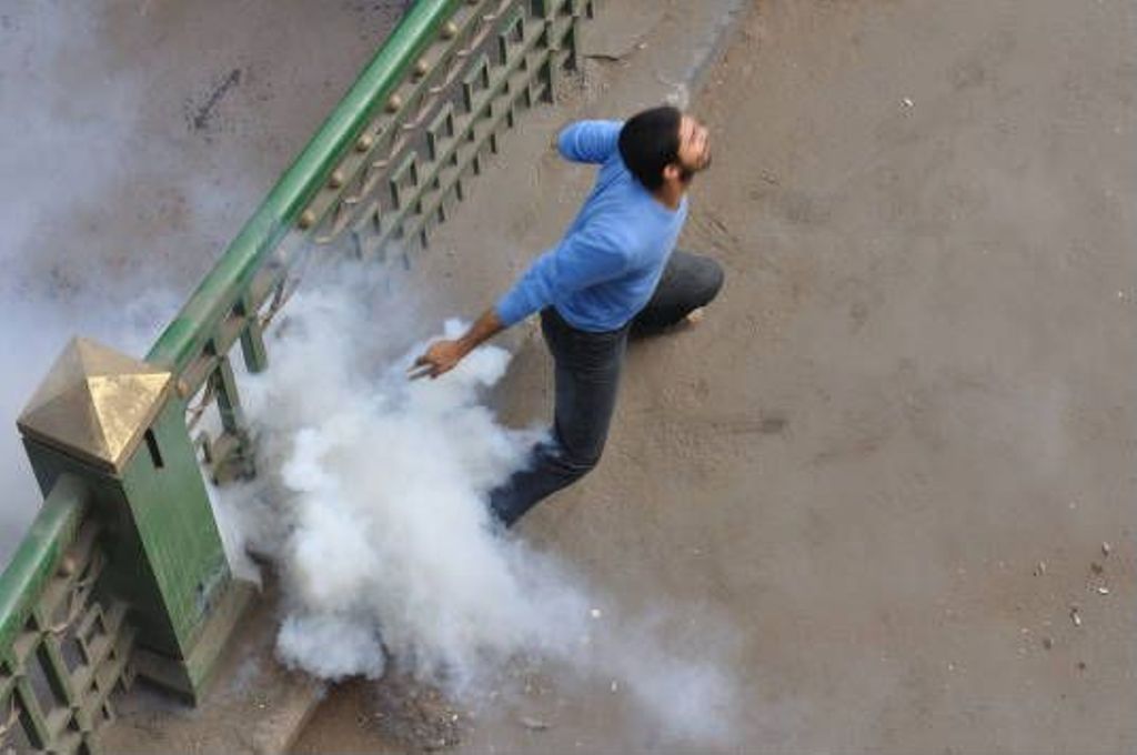 Miniature of Demonstrator throwing a can of tear gas next to the Egyptian Museum